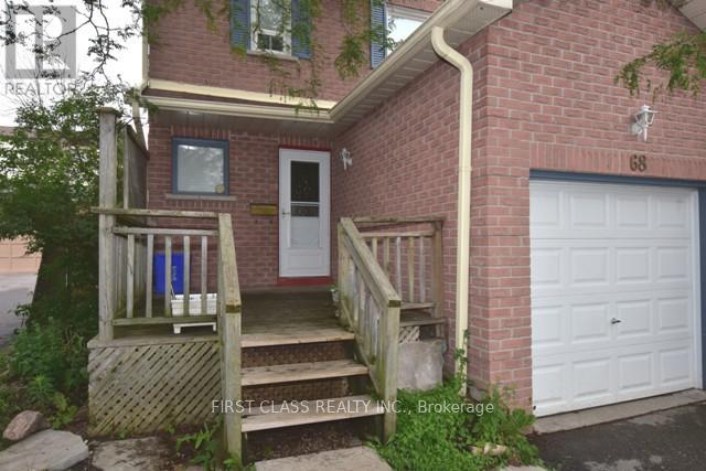 A red brick house with a white door and a white garage door.
