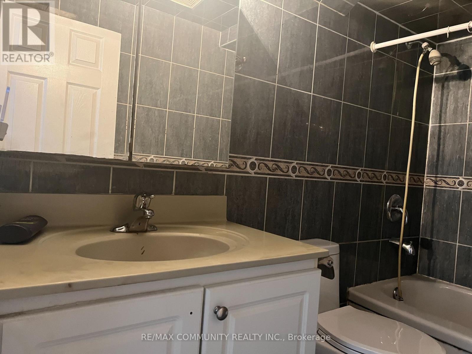A bathroom with a sink, toilet, and shower.
