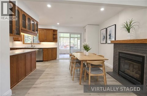 A modern kitchen with wooden cabinets and a dining table.