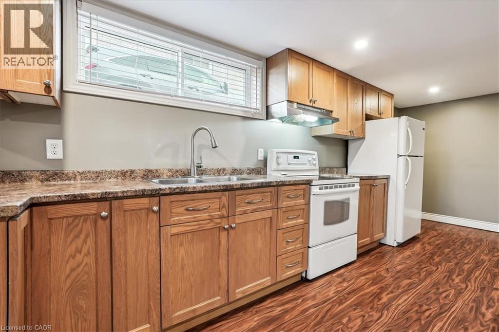 A kitchen with wooden cabinets and a white refrigerator.