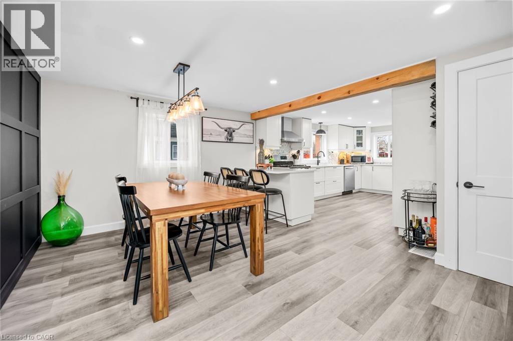 A modern dining room with a wooden table and chairs.