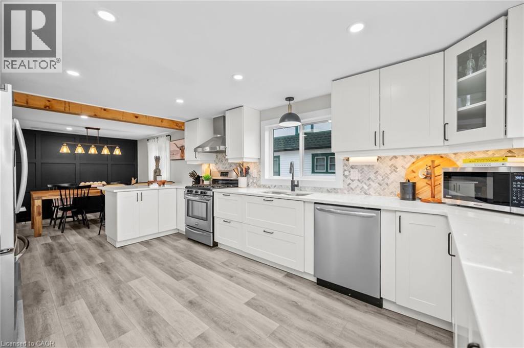 A modern kitchen with white cabinets and a wooden island.