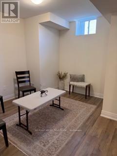 A realtor photo of a white table and two chairs in a room.