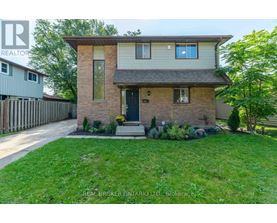 A house with a brown brick facade and a grey roof is for sale.