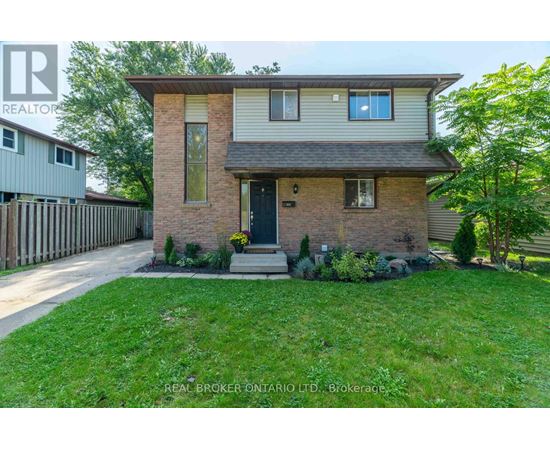 A house with a brown brick facade and a grey roof is for sale.