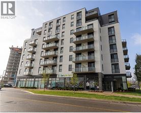 A modern apartment building with balconies and a glass entrance.