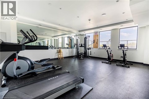 A gym with treadmills, elliptical machines, and stationary bikes.