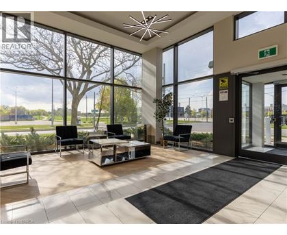 A waiting area with a glass wall and a view of the outside.