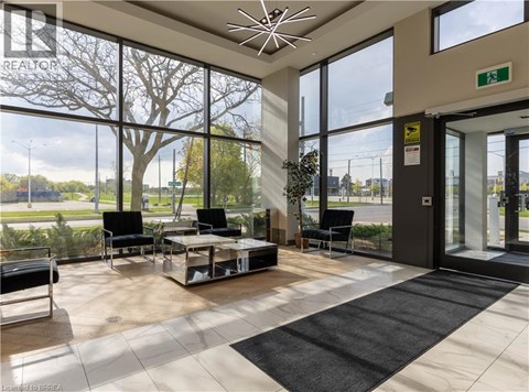 A waiting area with a glass wall and a view of the outside.