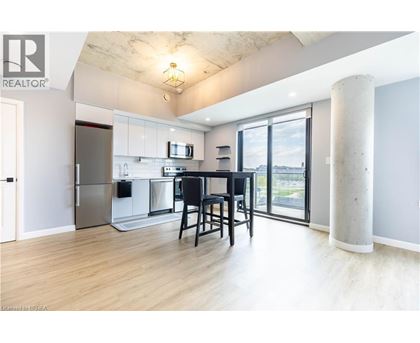 A modern kitchen with a dining table and chairs.