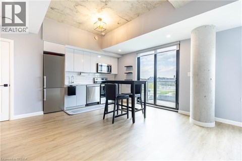 A modern kitchen with a dining table and chairs.