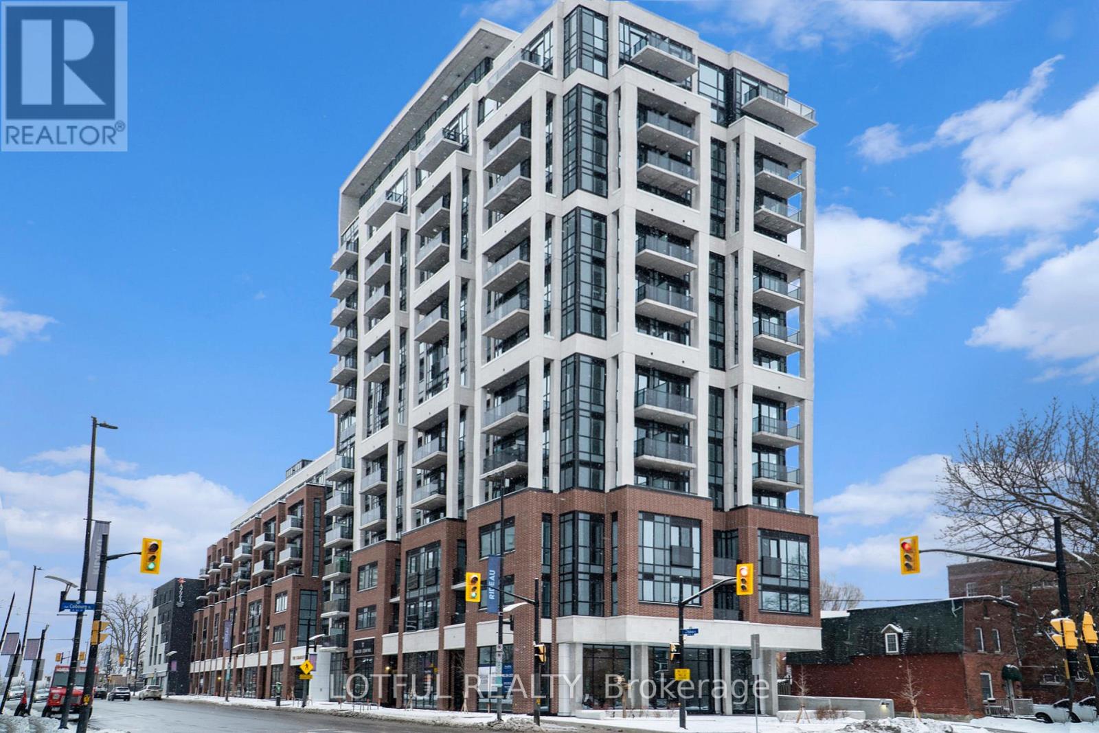 A tall building with many windows is the main focus of the image.