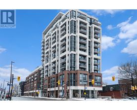 A tall building with many windows is the main focus of the image.