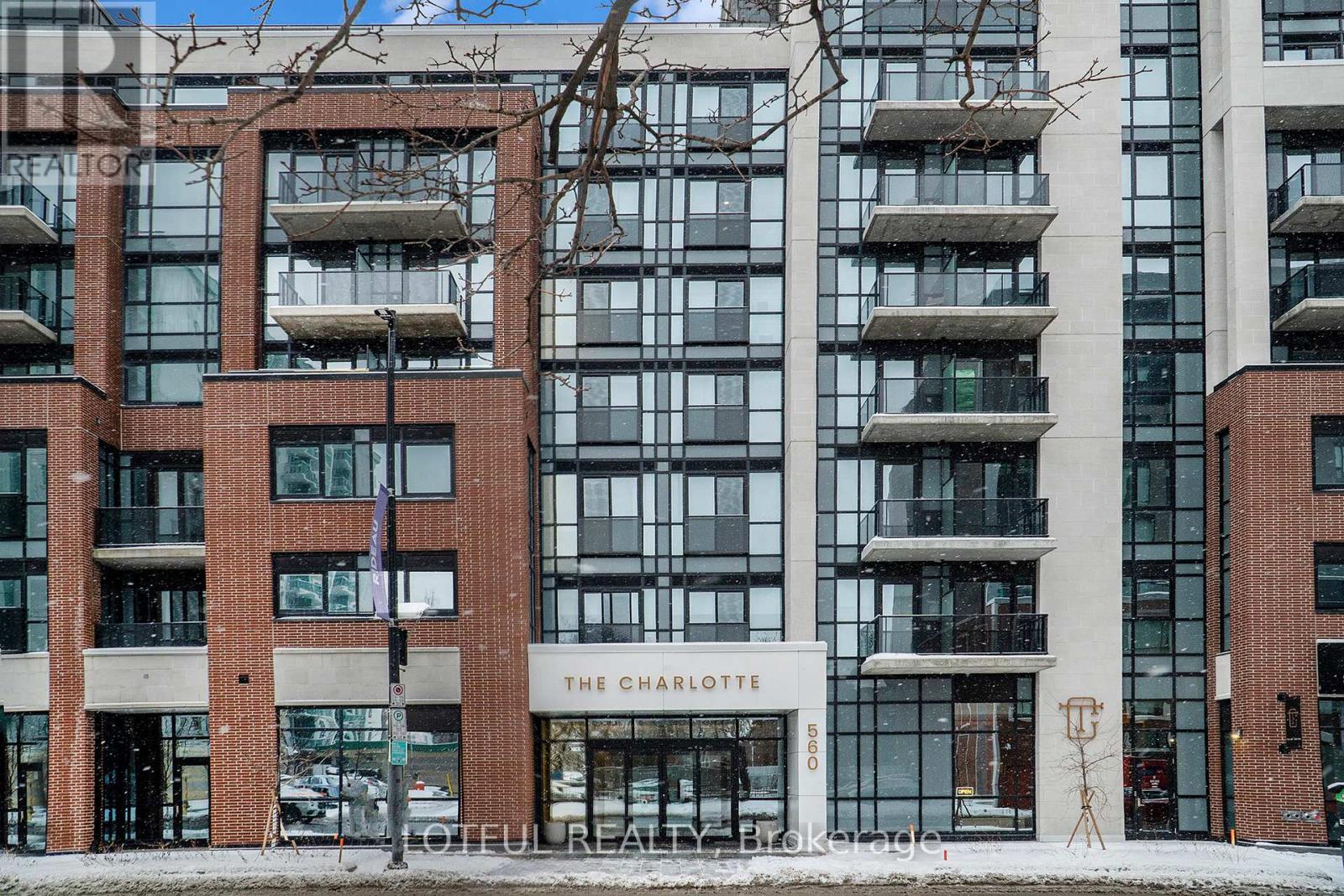 The Charlotte building is a modern structure with a combination of glass and brick.