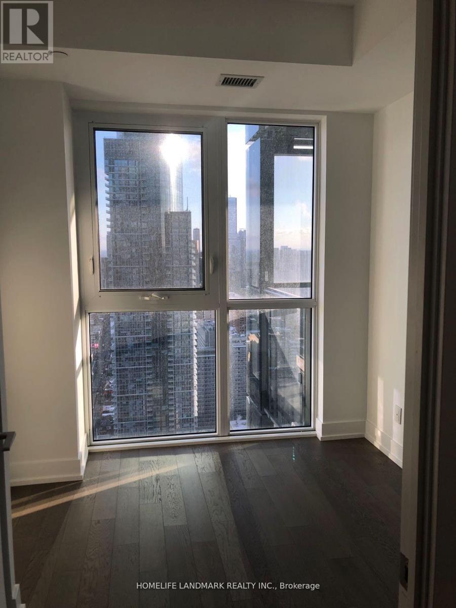 A room with a large window showing a cityscape.