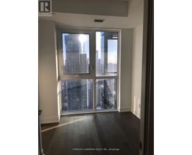 A room with a large window showing a cityscape.