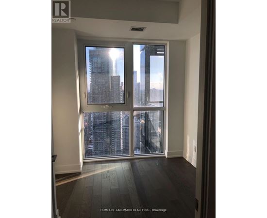 A room with a large window showing a cityscape.