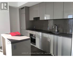 A modern kitchen with a red towel on the counter.