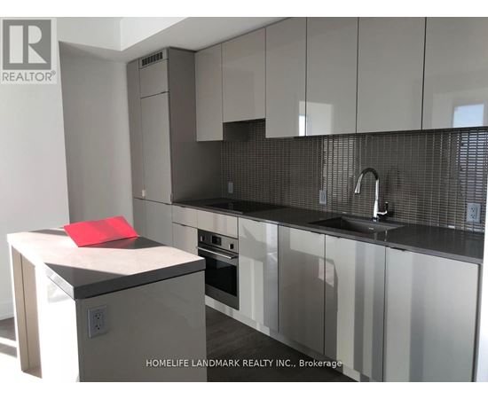 A modern kitchen with a red towel on the counter.