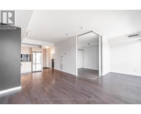 A modern kitchen with a table and a refrigerator.