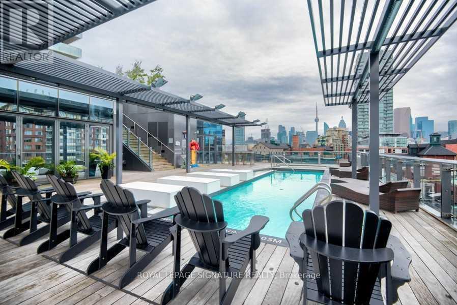 A pool area with lounge chairs and a hot tub.
