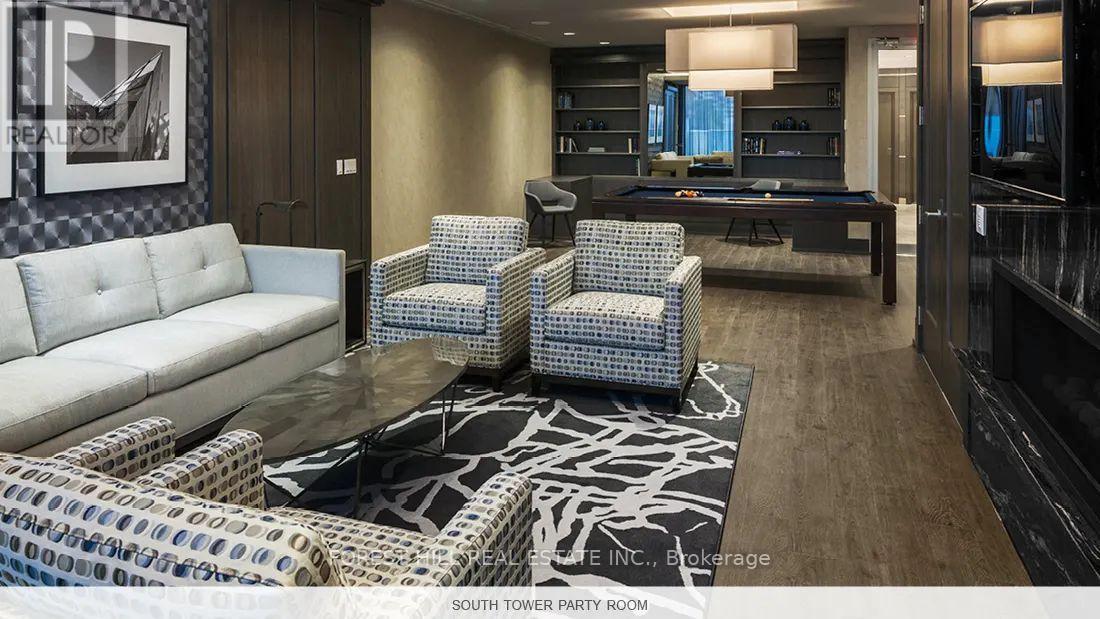 A party room with a pool table and a couch.