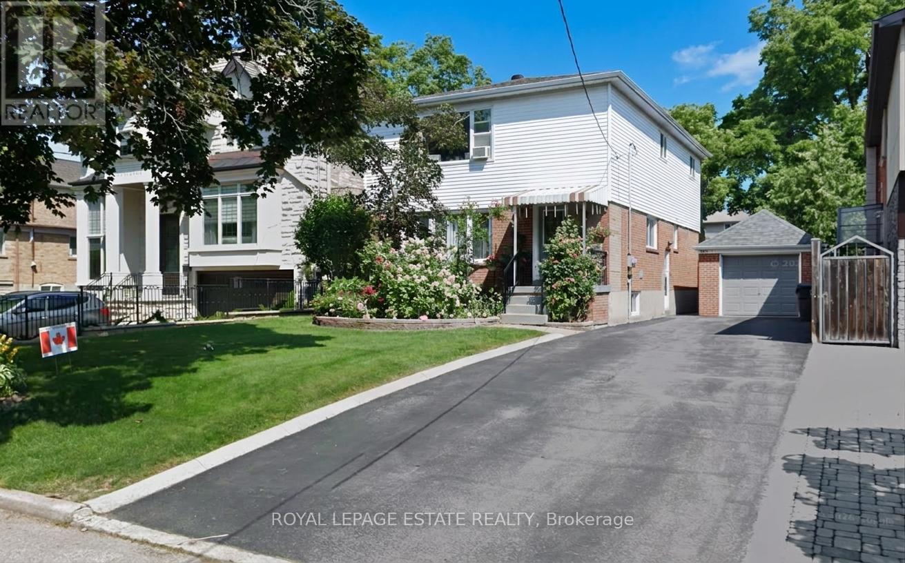 A residential street with houses and a Royal LePage Estate Realty sign.
