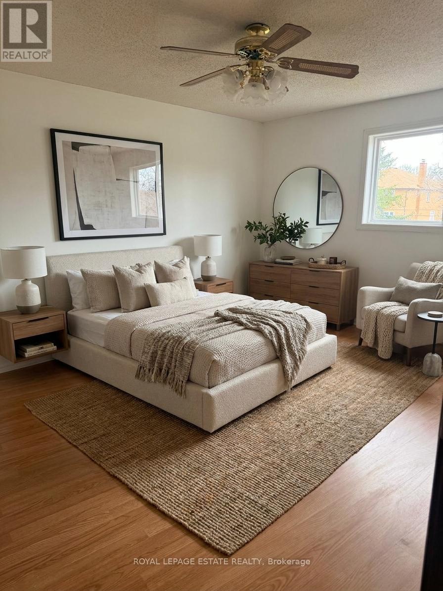 A bedroom with a bed, nightstands, and a chair.