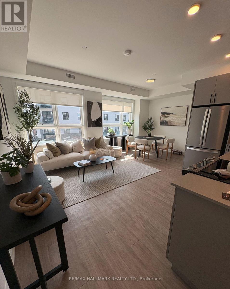 A modern living room with a kitchen area in the background.