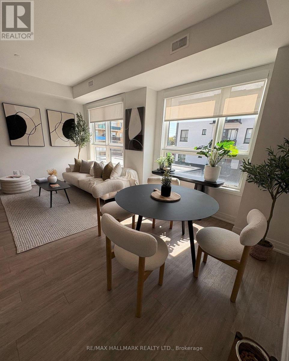 A living room with a round table and chairs.