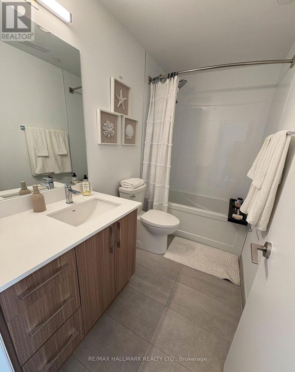 A bathroom with a sink, toilet, and shower.