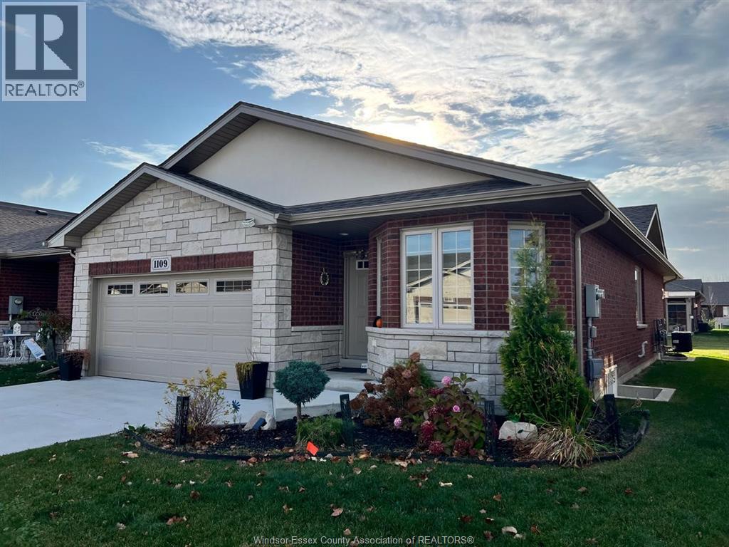 A house with a well-maintained lawn and landscaping in front.