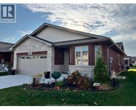 A house with a well-maintained lawn and landscaping in front.