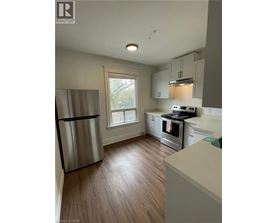 A kitchen with a refrigerator, stove, and oven.