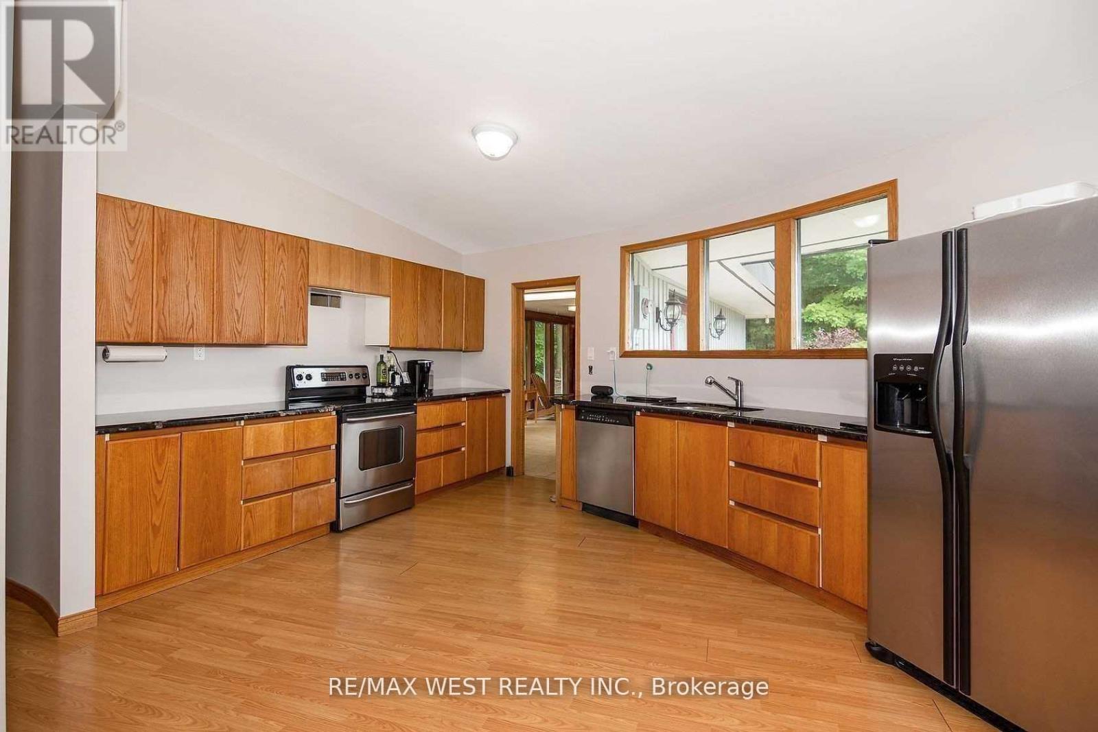 A kitchen with wooden cabinets and stainless steel appliances.