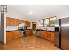 A kitchen with wooden cabinets and stainless steel appliances.