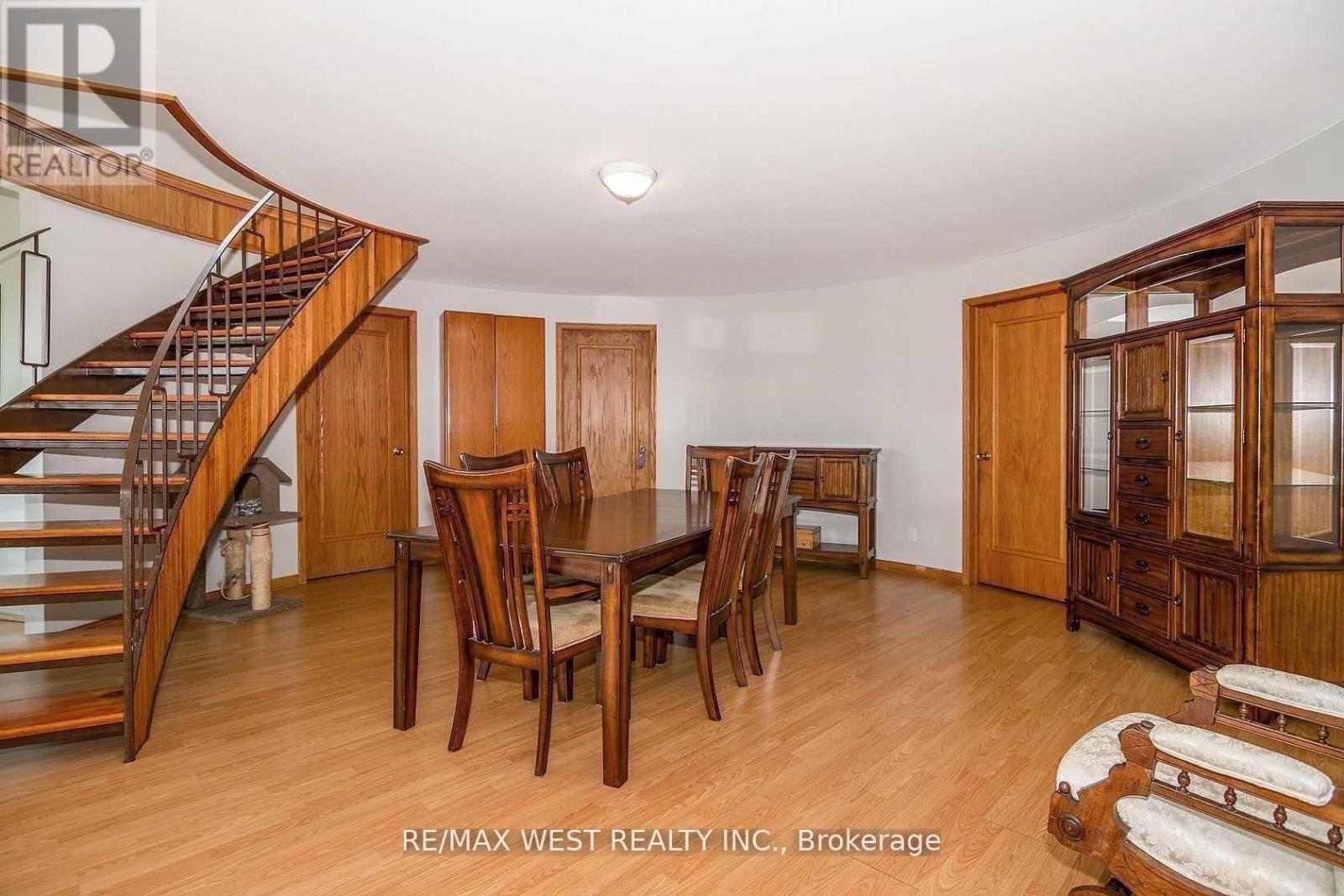 A dining room with a wooden table and chairs.