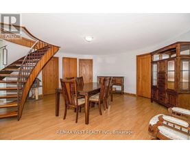 A dining room with a wooden table and chairs.