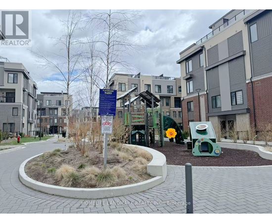A sign in front of a building with a playground in the background.