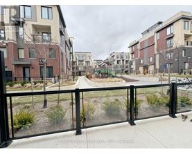 A view of a residential area with apartment buildings and a fenced walkway.