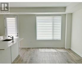 A room with a sink and a window with blinds.