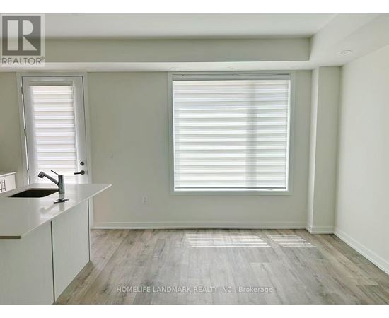 A room with a sink and a window with blinds.