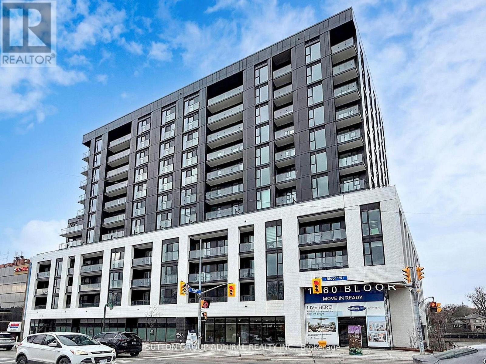 A modern multi-story building with a sign that reads "60 BLOR" in front of it.