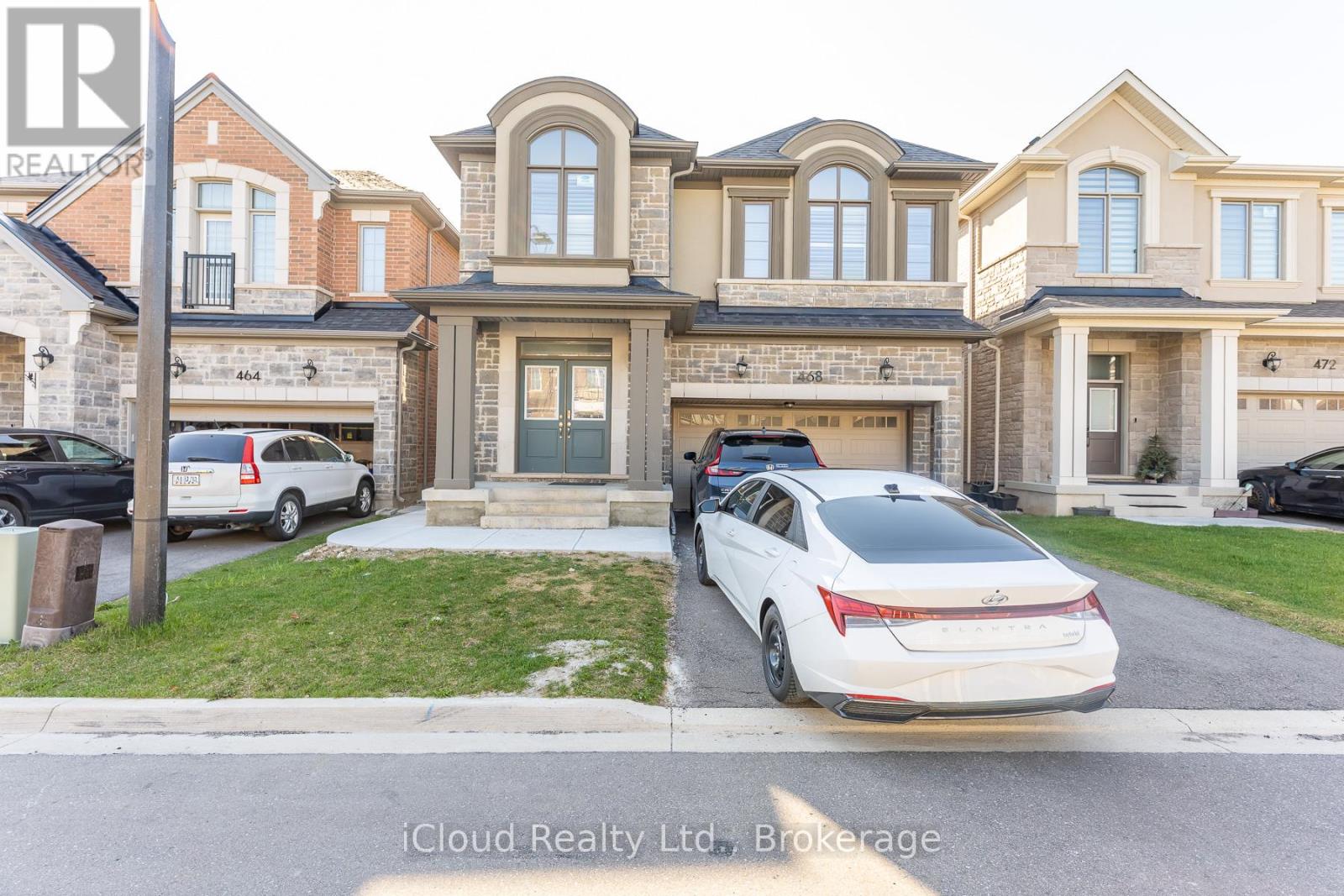 A real estate photo shows a house under construction with a partially completed garage.