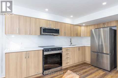 A kitchen with wooden cabinets and stainless steel appliances.