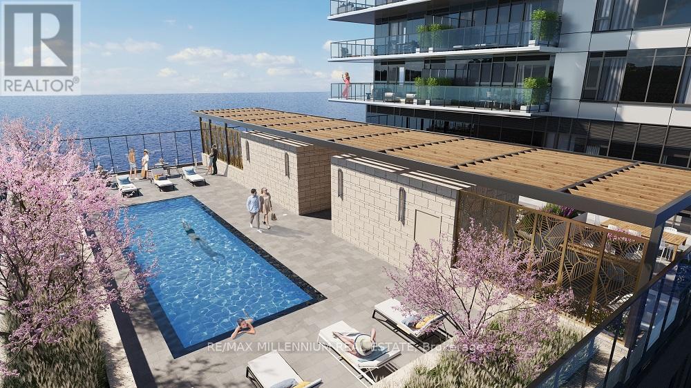 A pool surrounded by a deck and a building in the background.