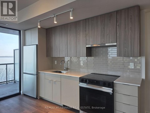 A modern kitchen with a stove top oven and a sink.