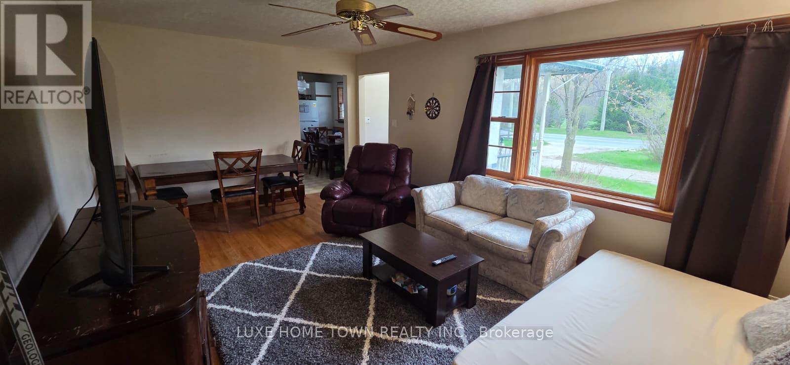 A living room with a flat screen TV and a couch.