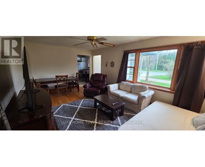 A living room with a flat screen TV and a couch.
