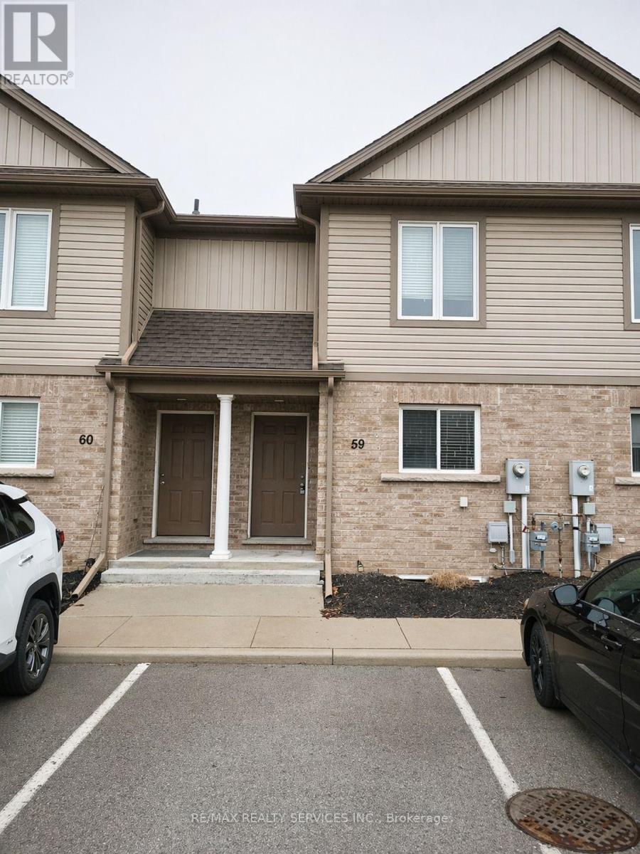 A two-story residential building with a garage door and a car parked in front.